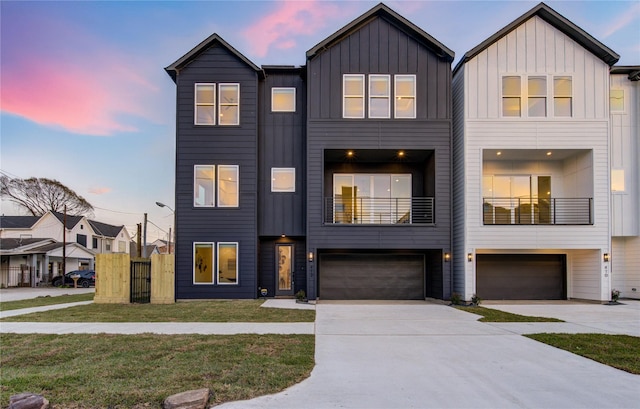 view of front of home featuring driveway, a garage, board and batten siding, and a yard