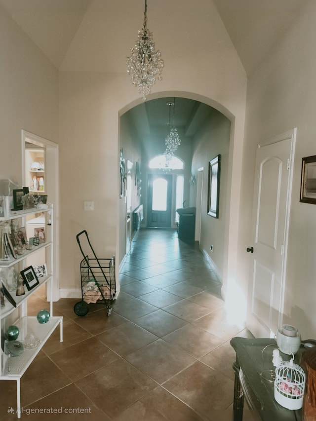 hall with a chandelier, high vaulted ceiling, arched walkways, tile patterned flooring, and baseboards