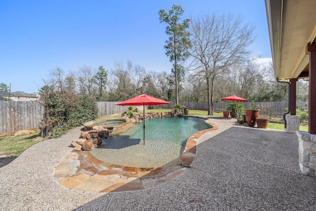 view of swimming pool featuring a patio area, a fenced backyard, and a pool with connected hot tub