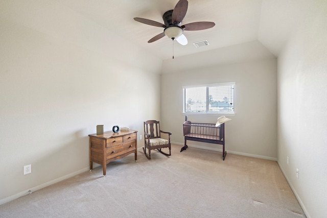 sitting room with lofted ceiling, light colored carpet, a ceiling fan, baseboards, and visible vents