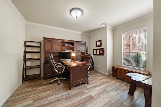 home office featuring ornamental molding, light wood-type flooring, visible vents, and baseboards