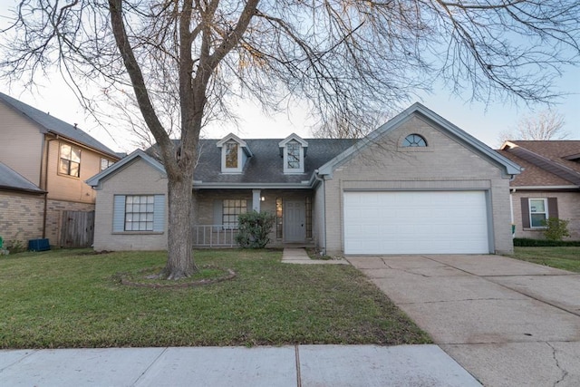 view of front of home with a garage, a front yard, concrete driveway, and brick siding