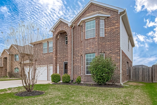 traditional home featuring brick siding, concrete driveway, an attached garage, a front yard, and fence