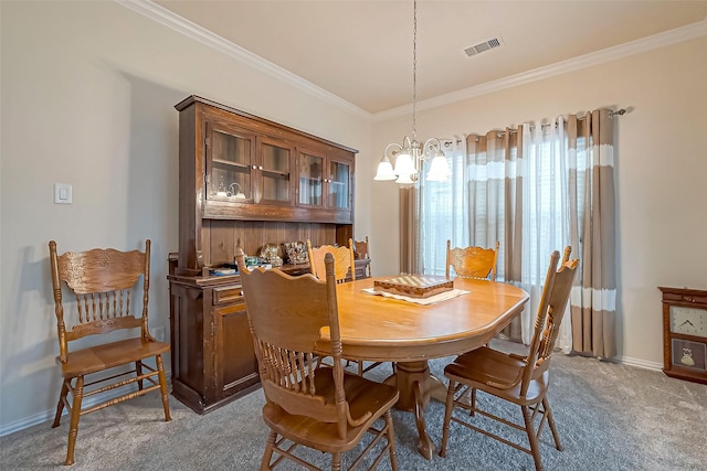 carpeted dining area with an inviting chandelier, baseboards, visible vents, and crown molding