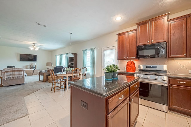 kitchen featuring black microwave, light carpet, visible vents, open floor plan, and stainless steel range with gas stovetop