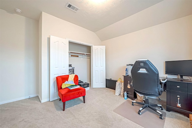 carpeted office featuring lofted ceiling, visible vents, and baseboards