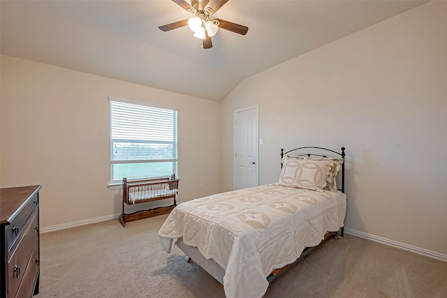 bedroom featuring vaulted ceiling, light carpet, a ceiling fan, and baseboards