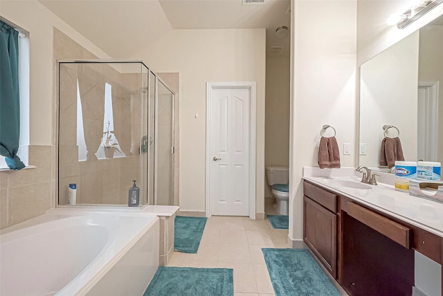 bathroom featuring a garden tub, tile patterned flooring, toilet, vanity, and a shower stall