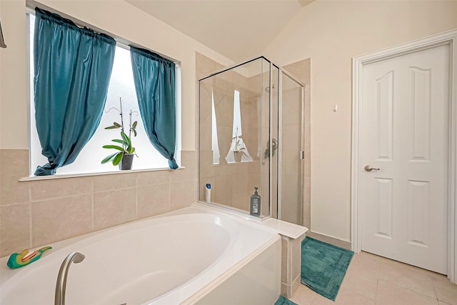 bathroom with a garden tub, a shower stall, and tile patterned floors