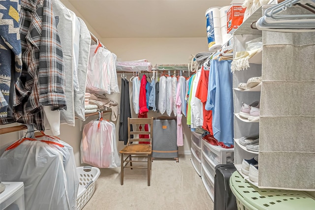 walk in closet featuring carpet flooring