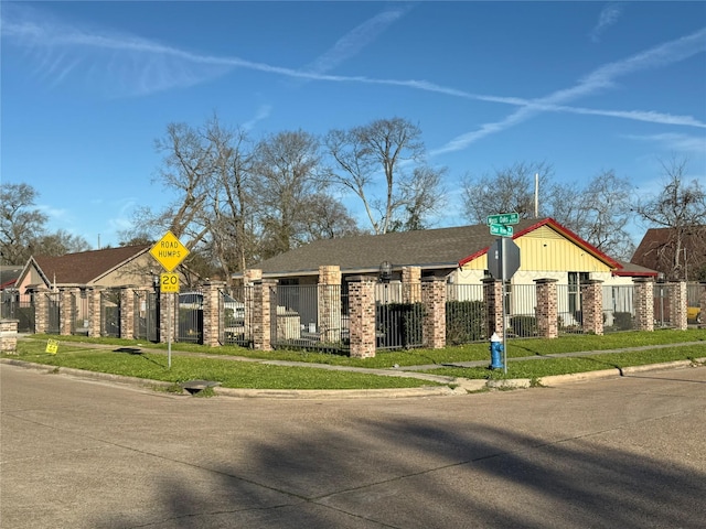 view of front of property with a fenced front yard and brick siding