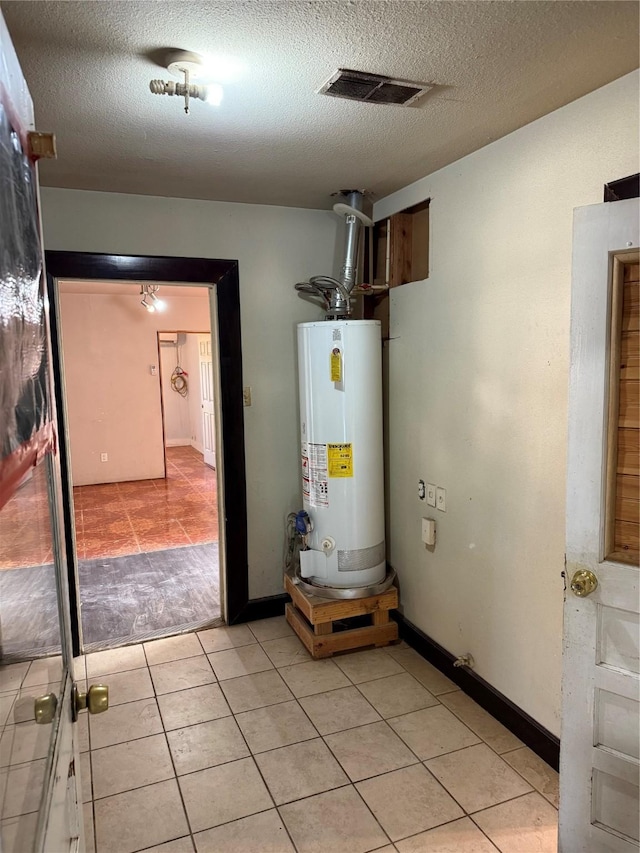 utility room with gas water heater and visible vents