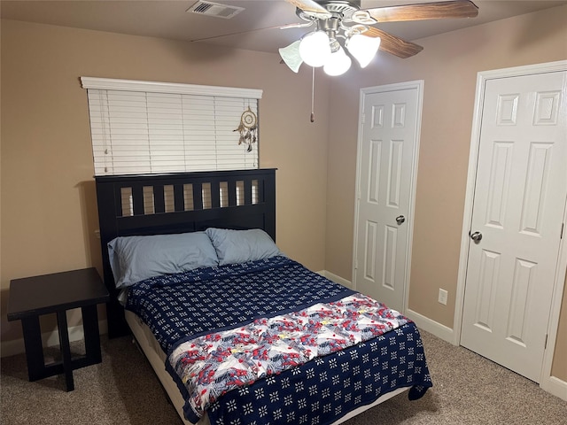 carpeted bedroom with baseboards, visible vents, and ceiling fan