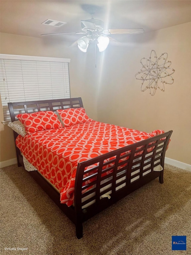 carpeted bedroom featuring visible vents, ceiling fan, and baseboards