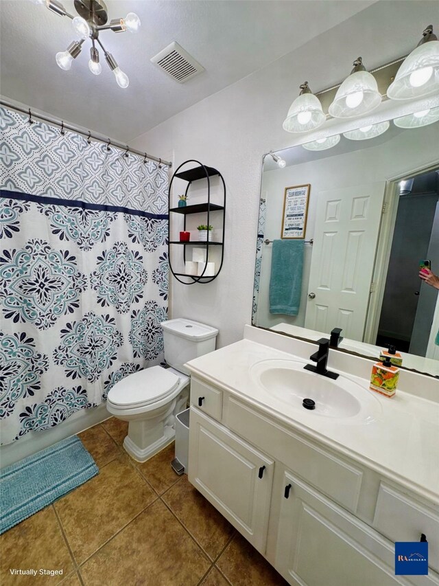 full bath featuring vanity, a shower with shower curtain, visible vents, tile patterned floors, and toilet