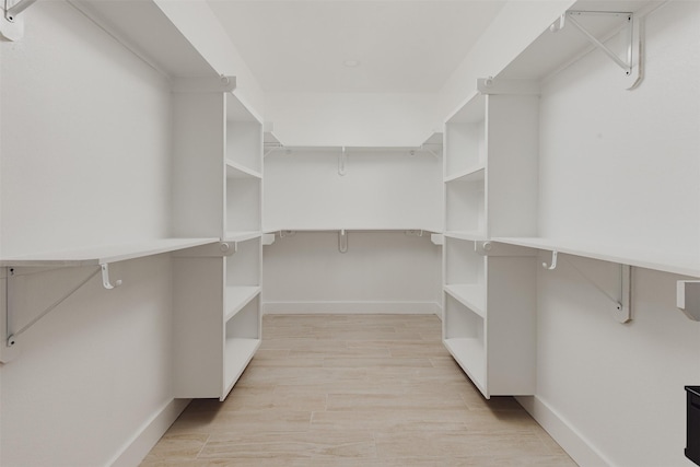 walk in closet featuring light wood-style flooring