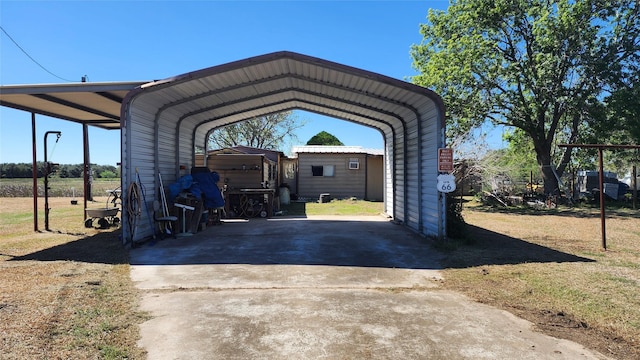 view of vehicle parking featuring driveway and a carport