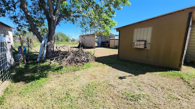 view of yard featuring a storage shed and an outbuilding