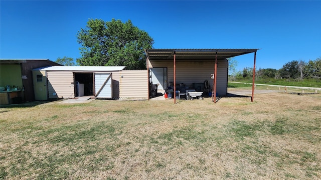 view of pole building with a carport and a lawn