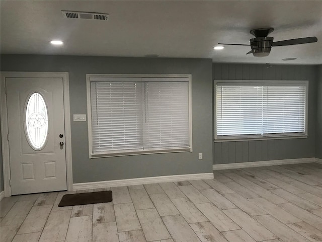 entryway with ceiling fan, wood finished floors, visible vents, and baseboards