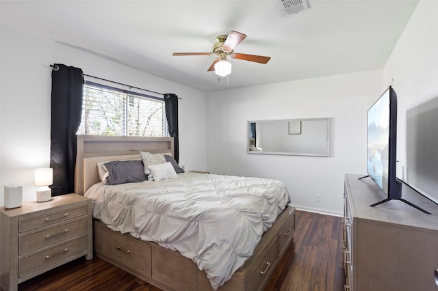 bedroom featuring ceiling fan, dark wood finished floors, visible vents, and baseboards