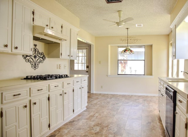 kitchen featuring light countertops, stainless steel dishwasher, a sink, gas cooktop, and under cabinet range hood