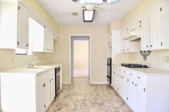 kitchen featuring visible vents, under cabinet range hood, light countertops, black appliances, and white cabinetry