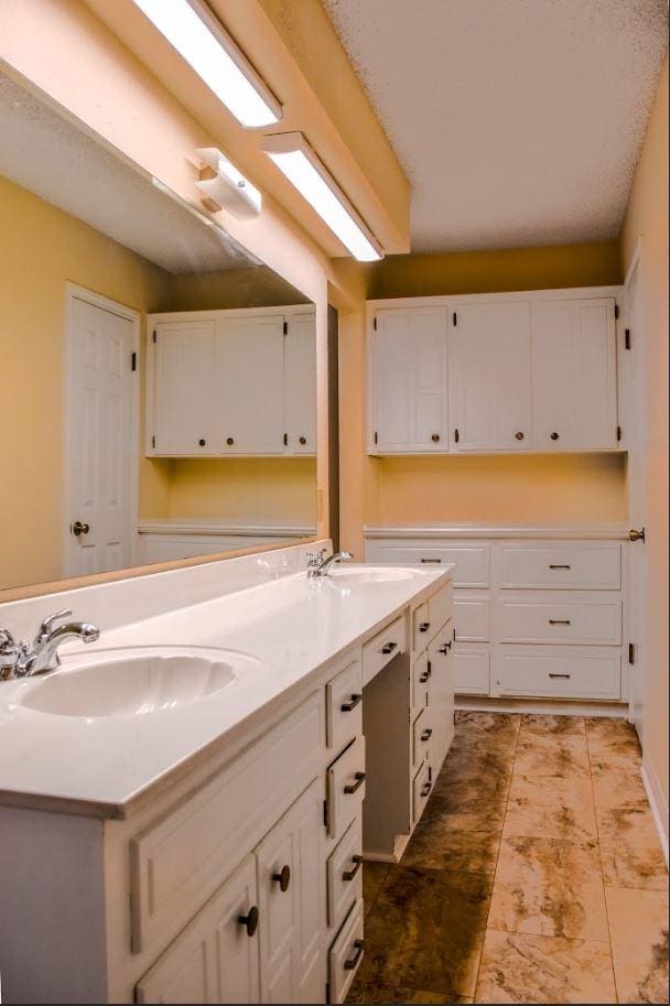 bathroom with double vanity and a sink