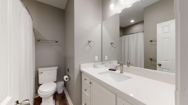 full bathroom with baseboards, vanity, toilet, and wood finished floors