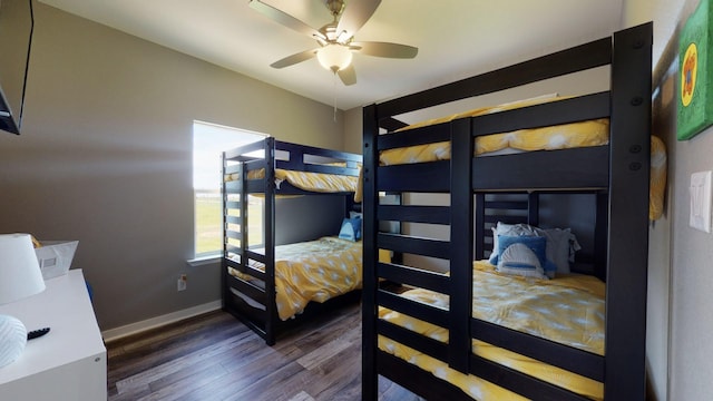 bedroom with dark wood-style floors, baseboards, and a ceiling fan