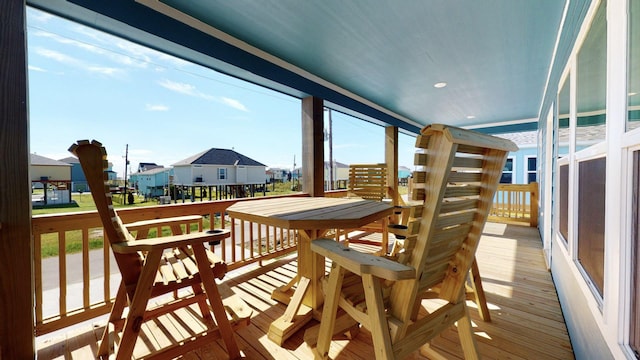 sunroom featuring a residential view