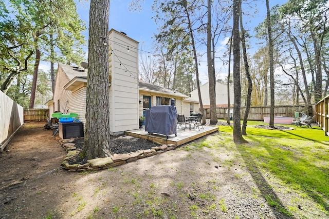 view of yard with a fenced backyard and a deck