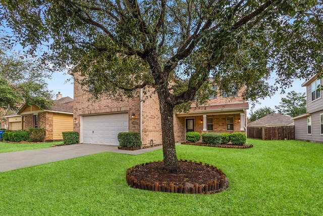 view of front of property with concrete driveway, brick siding, a front yard, and fence