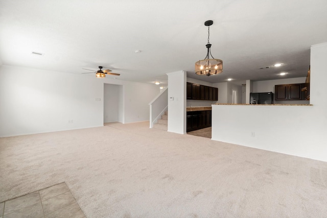 unfurnished living room with light tile patterned floors, recessed lighting, light carpet, a ceiling fan, and stairway