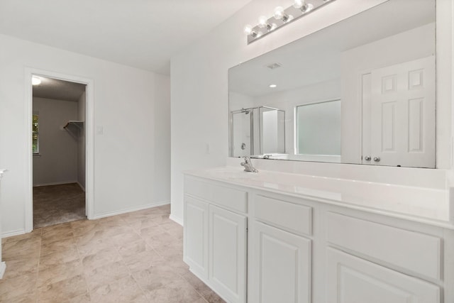 full bathroom with visible vents, vanity, baseboards, a spacious closet, and a shower stall