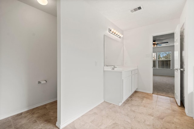 bathroom with ceiling fan, vanity, visible vents, and baseboards