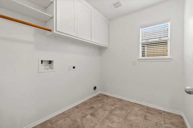 clothes washing area with hookup for a washing machine, cabinet space, visible vents, hookup for an electric dryer, and baseboards