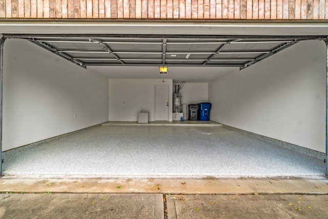 garage with water heater and a garage door opener