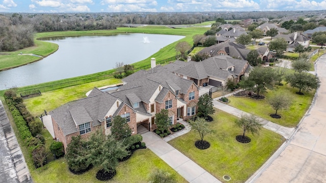 bird's eye view with a water view and a residential view