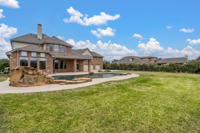 20803 Fairhaven Crossing Dr, Cypress, TX 77433 - back of house with brick siding, a lawn, roof with shingles, a chimney, and a patio area