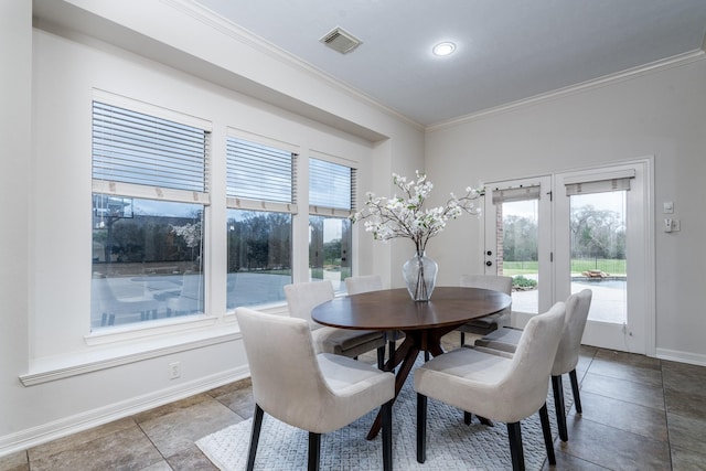 dining room featuring visible vents, crown molding, and baseboards