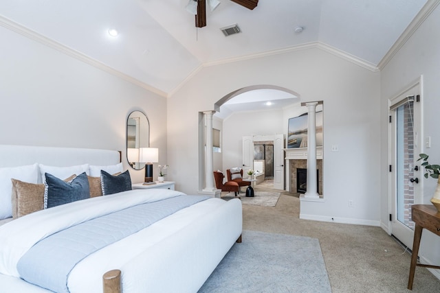 bedroom with lofted ceiling, ornate columns, and carpet floors