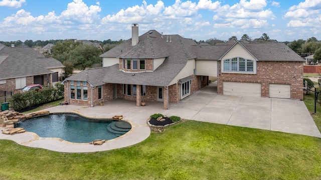 view of swimming pool with fence, a patio, and a yard