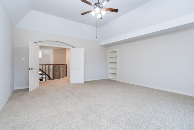 20803 Fairhaven Crossing Dr, Cypress, TX 77433 - empty room with light colored carpet, built in features, baseboards, ceiling fan, and high vaulted ceiling