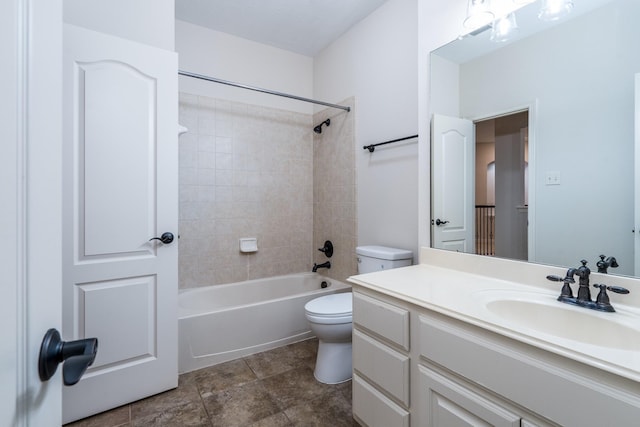 bathroom with washtub / shower combination, vanity, and toilet