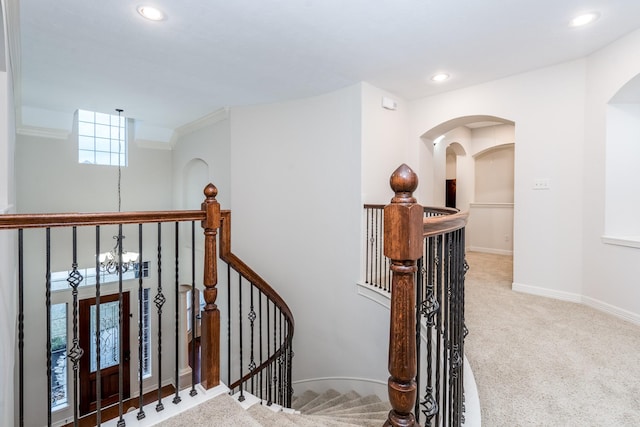 stairs featuring arched walkways, recessed lighting, carpet flooring, a chandelier, and baseboards