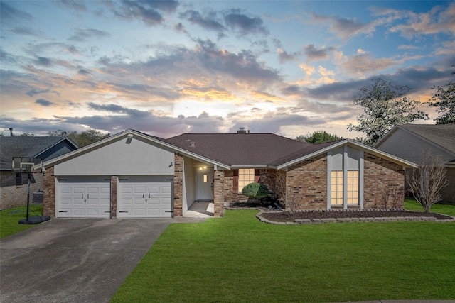 mid-century home with a garage, driveway, brick siding, and a front yard