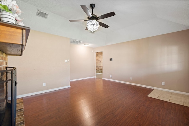 unfurnished living room featuring baseboards, visible vents, and wood finished floors