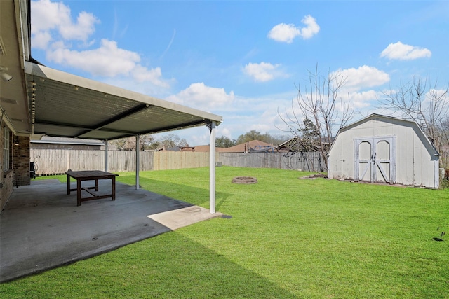 view of yard with a patio area, a shed, a fenced backyard, and an outdoor structure