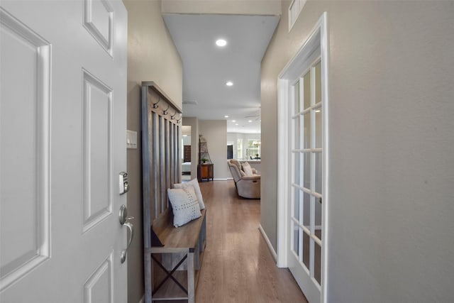 doorway to outside featuring wood finished floors and recessed lighting